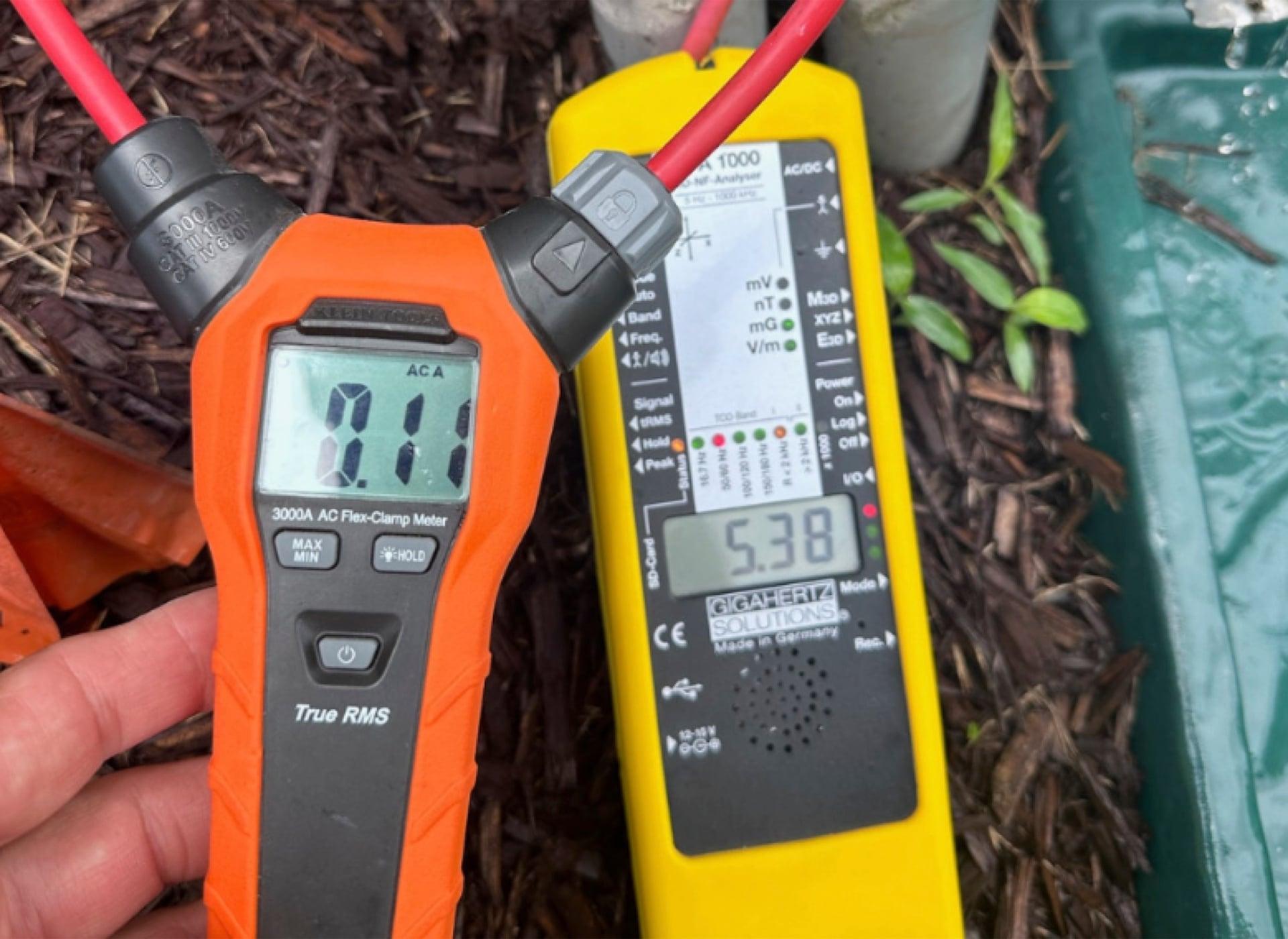 AC clamp meter and Gigahertz Solutions EMF analyzer measuring electromagnetic fields