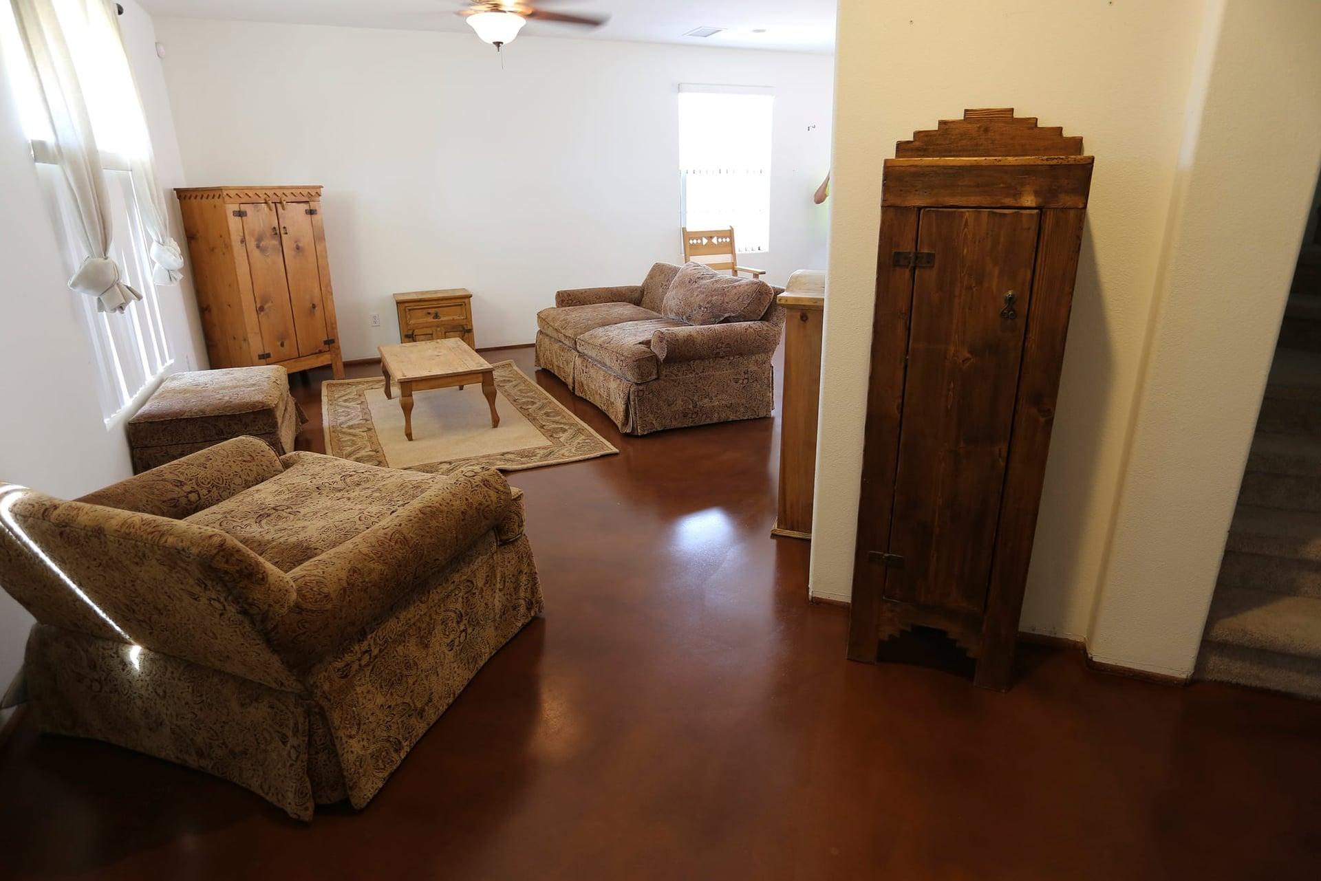 Family room with southwestern pine furniture and a warm cordoba-stained polished concrete floor