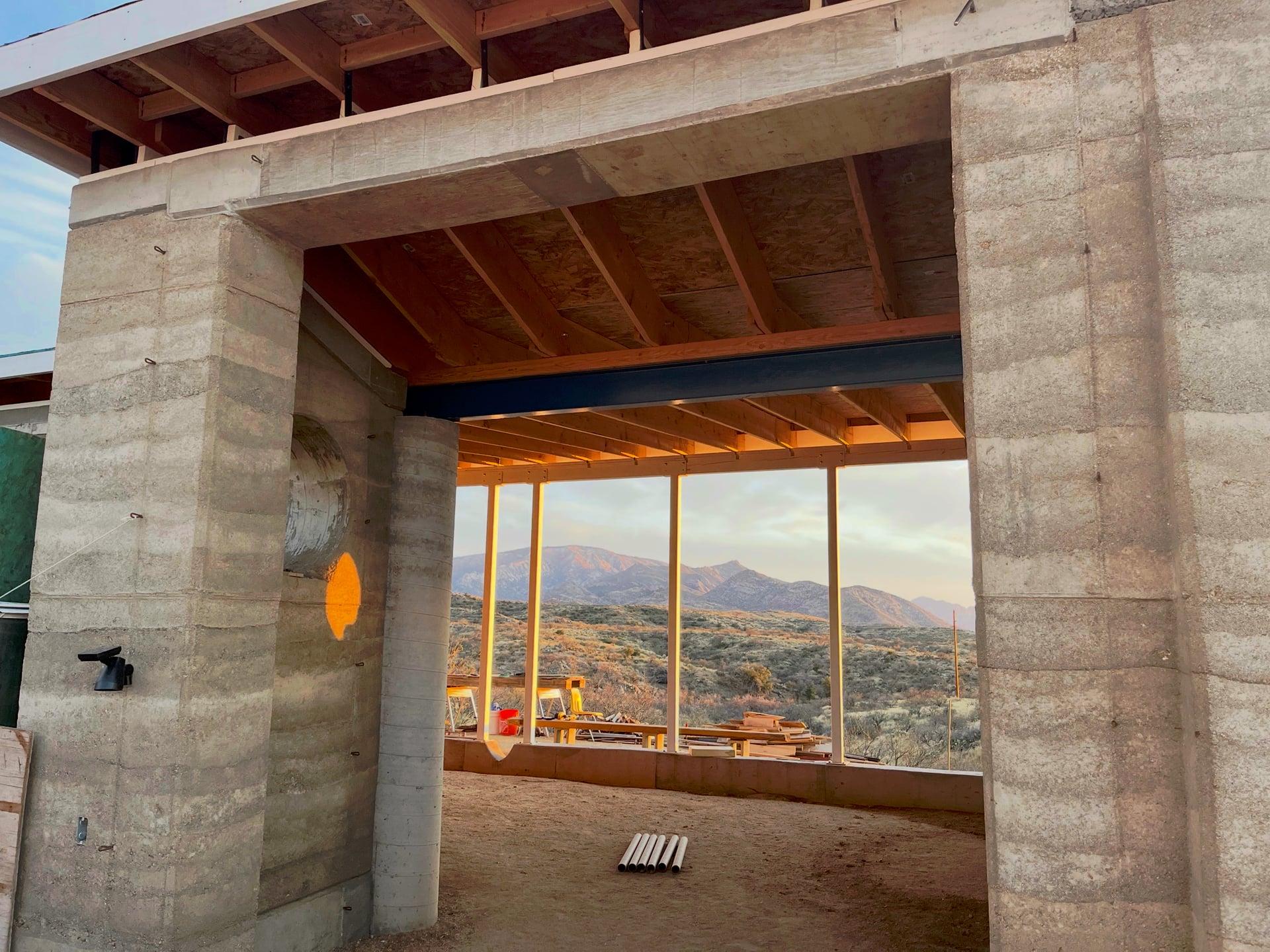 Great room window opening framing valley and mountain views